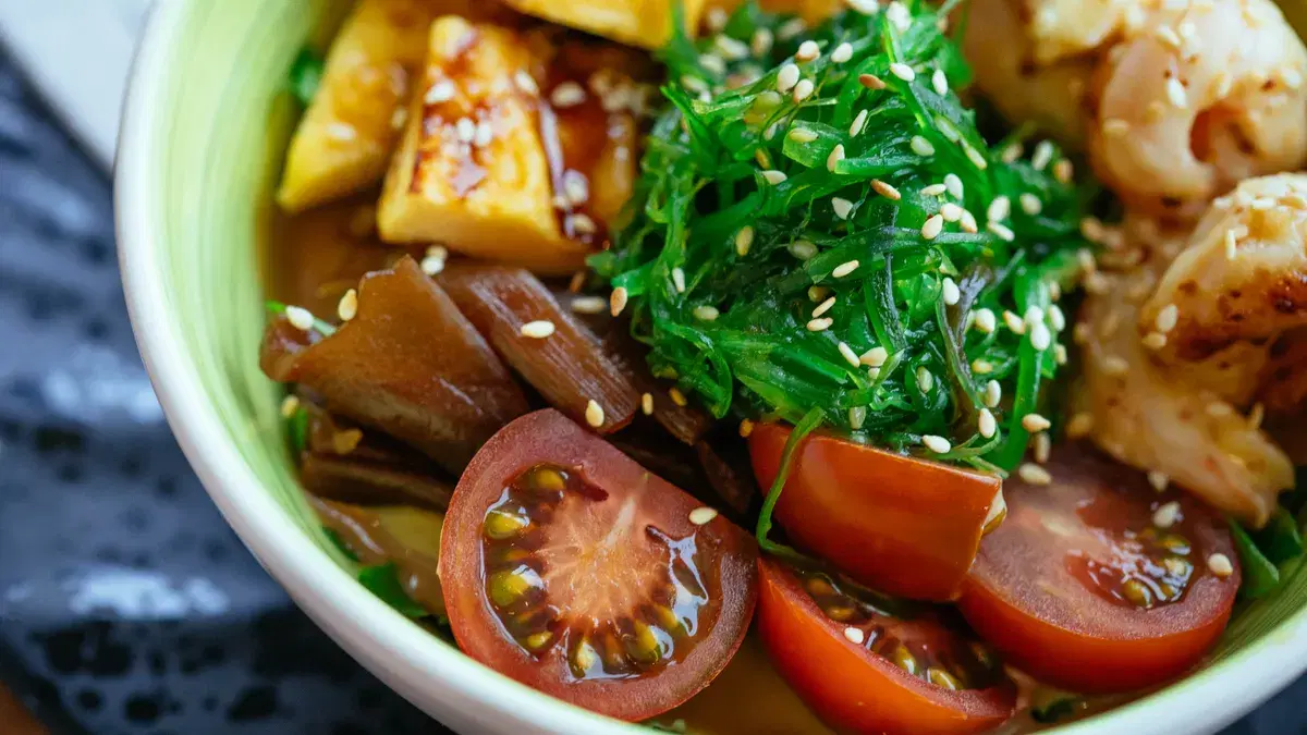 A colorful vegan poke bowl with fresh vegetables, tofu, and sesame seeds.